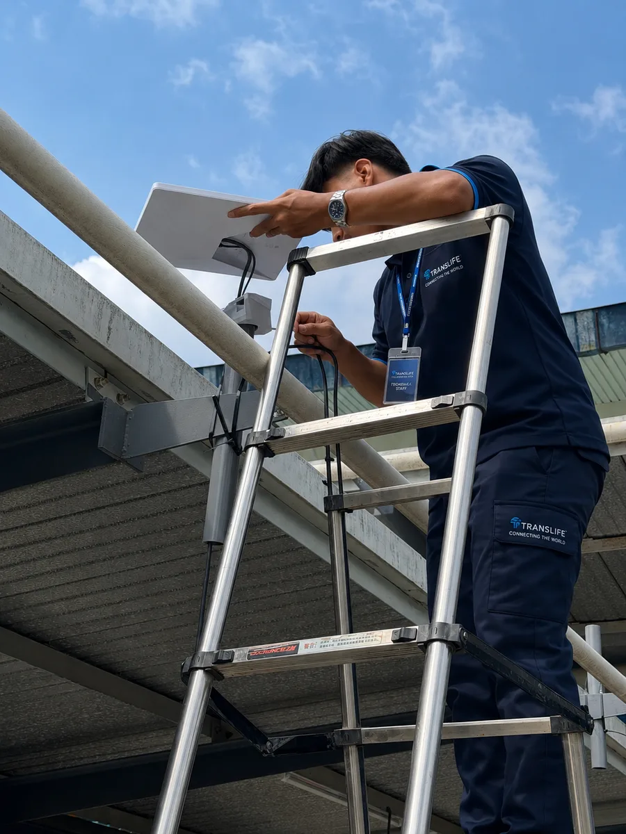 Translife technician installing a Starlink terminal on a rooftop for event internet